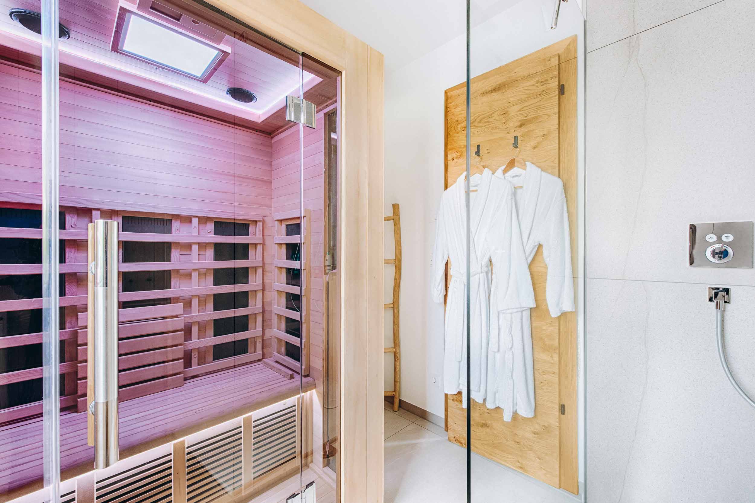 Infrared cabin with bathrobes in a chalet bathroom